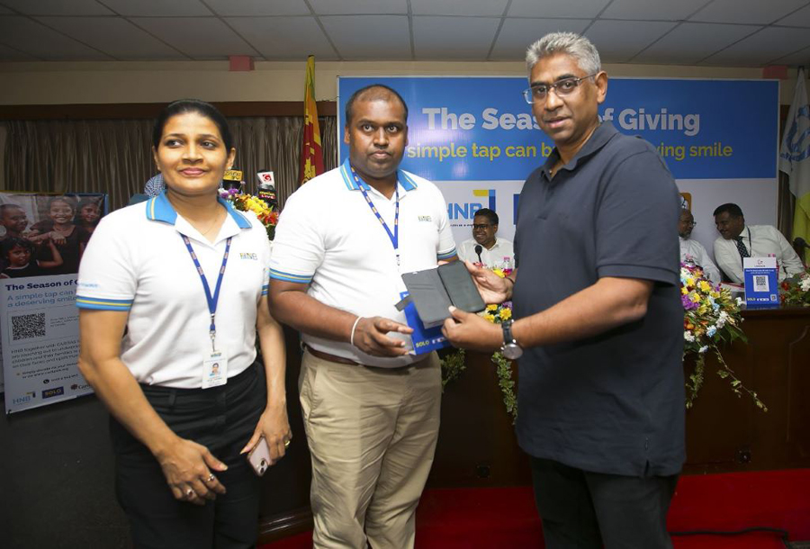 Presidents Counsel Faiszer Musthapha making the first donation via the HNB SOLO digital payment app